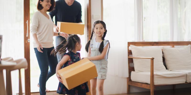4 Tips for Move-Up Home Buyers Family running into a home